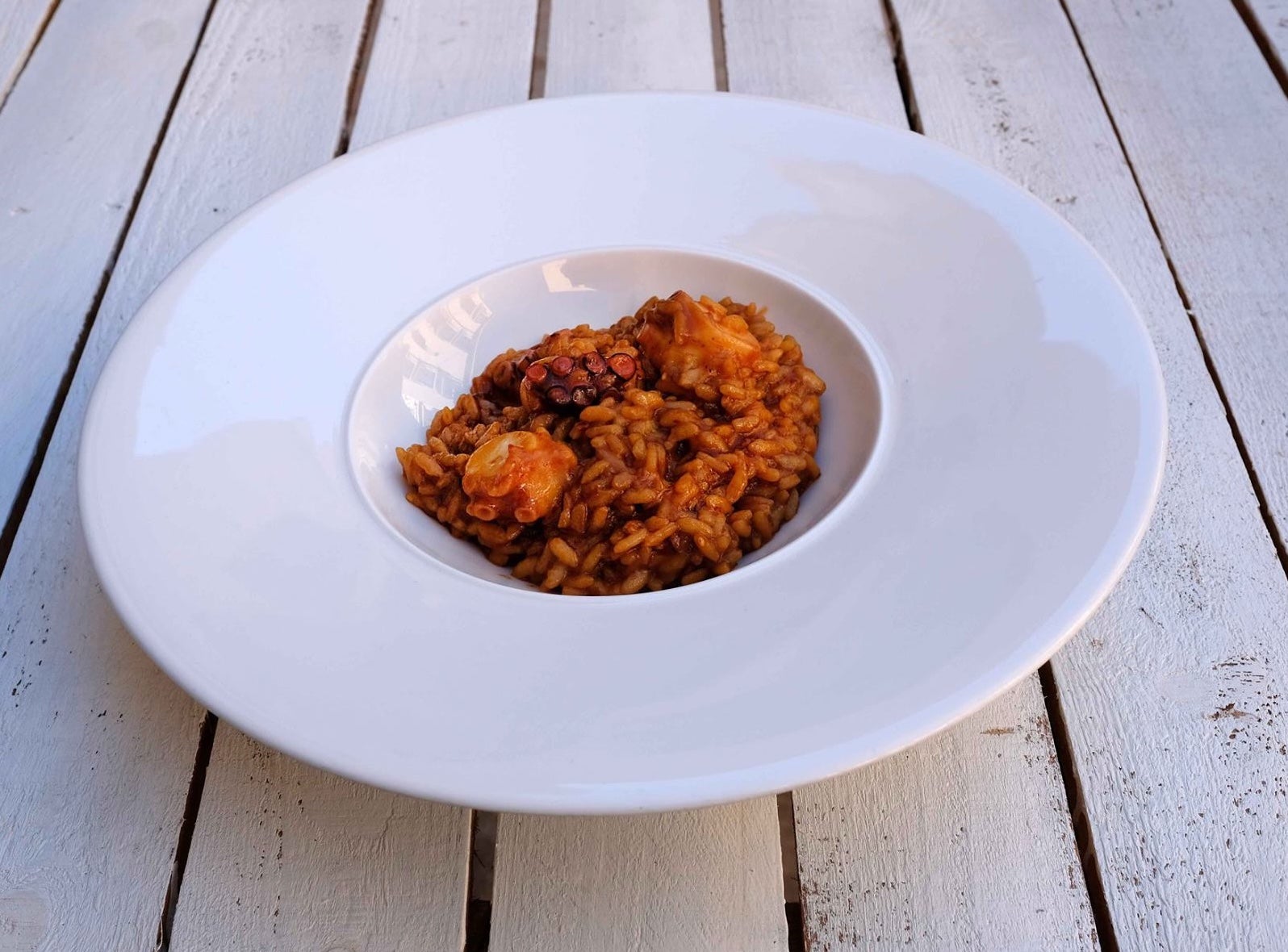 Arròs a la masqueta amb pebrots de romesco i pop roquer | Facebook El Llagut